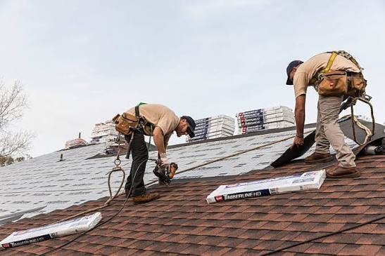 Crew replacing shingles on a roof